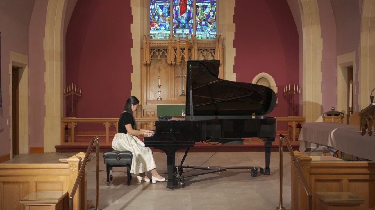 Chenyi performing a solo piano recital on a grand piano
