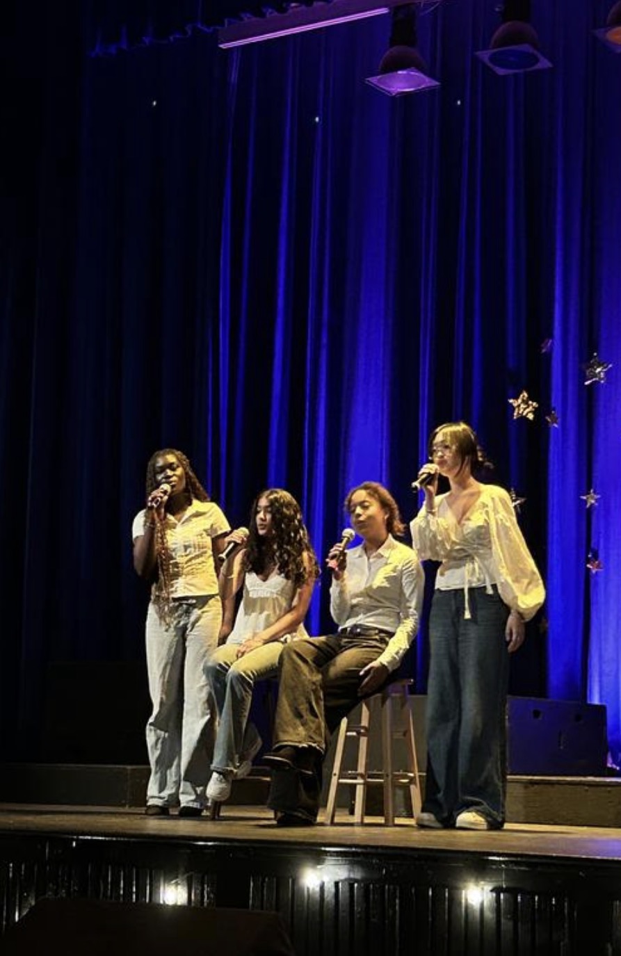 Blessing performing on stage with the C-Flats Vocal Jazz Ensemble